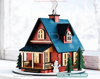May include: A miniature wooden house with a red exterior, blue roof, and black trim. The house features a chimney with smoke, a porch, and two green trees. A snowman is in front of the house. The text "DIGITAL DOWNLOAD" is at the bottom.