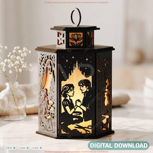 May include: A black and brown decorative lantern with intricate cut-out designs. The lantern features a silhouette of a couple, a castle, and other decorative elements. The text "DIGITAL DOWNLOAD" is at the bottom. The lantern is approximately 6 inches tall.