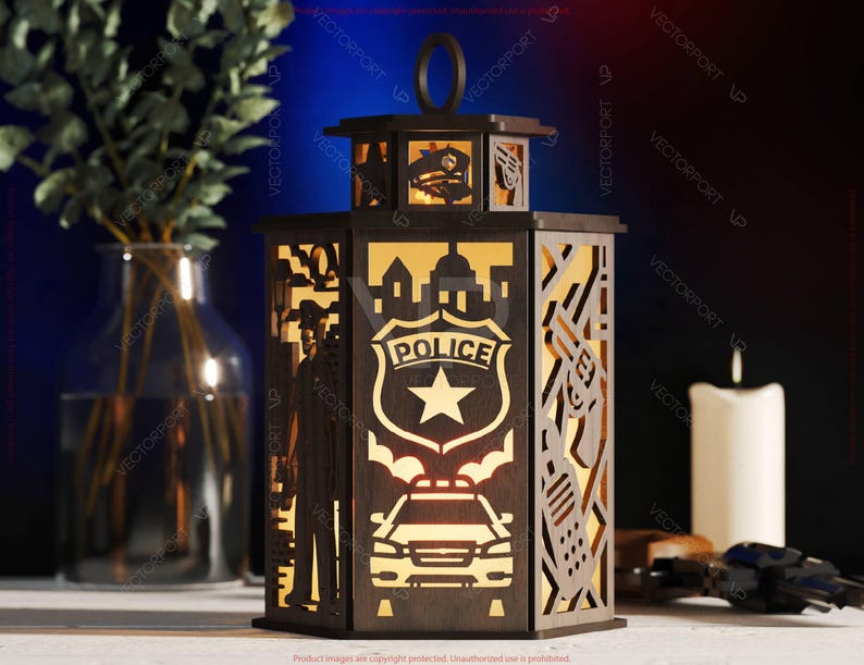 May include: A wooden lantern with a police theme. The lantern features cut-out designs of a police badge, a police car, a silhouette of a police officer, and city buildings. The lantern has a handle and is illuminated from within, creating a warm glow.