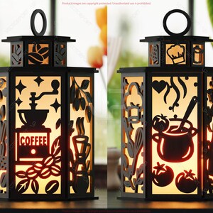 May include: Black metal lantern with cut-out designs. One side features a coffee grinder and the word "COFFEE". The other side shows a chef's hat and a pot of food. The lantern has a handle and is illuminated from within.