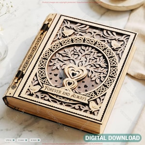 May include: A wooden book-shaped box with intricate laser-cut designs. The cover features a tree of life with hearts and the words "FOREVER AND ALWAYS." The box is light brown with dark brown accents and measures 1/8 inch thick.