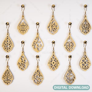 May include: Twelve pairs of laser cut wooden earrings in a teardrop shape with intricate designs. The earrings are displayed on a white background.