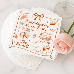 May include: White Friendsgiving dinner party napkins with brown illustrations of food and text. The text reads "Friendsgiving Dinner Party", "Let's Eat, Drink, and Be Thankful!", "The Bennett", and "10.29.2025". A stack of napkins is visible.