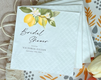 May include: White paper napkins with a lemon and floral design. The napkins are printed with the words "Bridal Shower" and the name "Victoria Julian" with the date "September 16th, 2025". The napkins have a textured surface.
