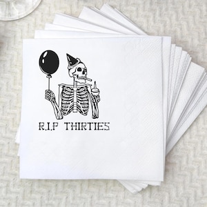 May include: White paper napkins with a black graphic of a skeleton holding a balloon and a drink, wearing a party hat, and smoking a cigarette. The text "R.I.P THIRTIES" is printed below the skeleton.