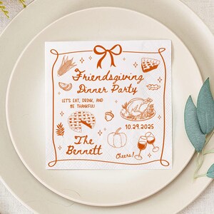 May include: A white Friendsgiving dinner party napkin with a brown border and illustrations of food and drink. Text includes "Friendsgiving Dinner Party", "Let's eat, drink, and be thankful!", "The Bennett", and the date 10.29.2025.