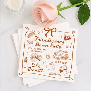 May include: White Friendsgiving dinner party napkins with a brown illustrated border. The napkins feature text and illustrations of food, including a turkey, pie, and pumpkin. The text reads "Friendsgiving Dinner Party" and "The Bennett".
