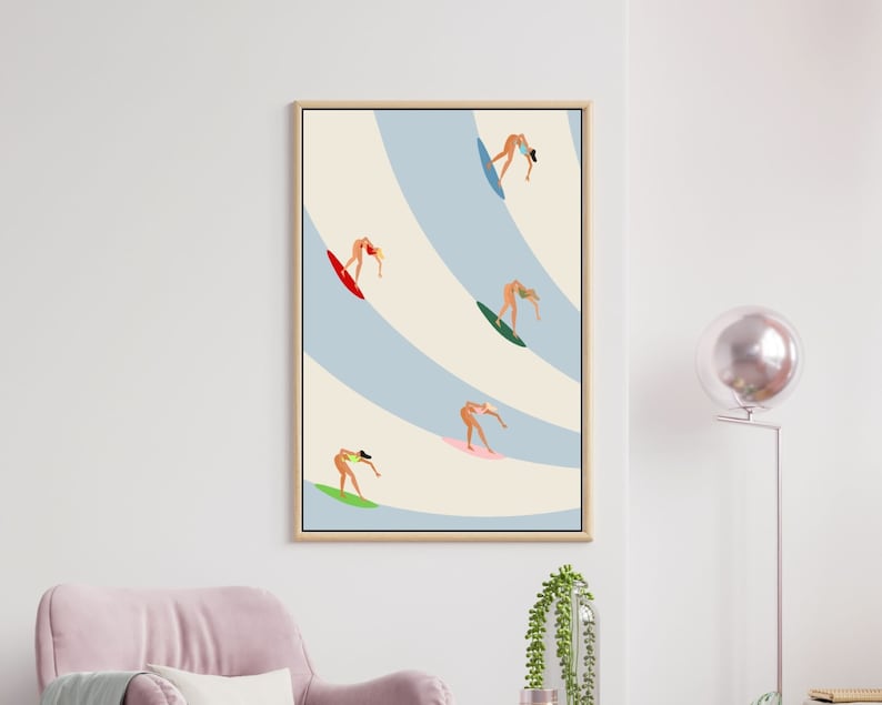 May include: A framed illustration of five figures surfing on waves. The figures are all women wearing bikinis and are depicted in different poses on their surfboards. The background is a light blue and cream color with wavy lines.