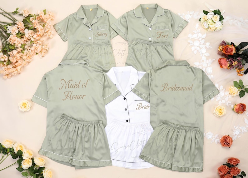 May include: Sage green satin pajama sets with white piping, embroidered with names and titles like "Sherry", "Tori", "Maid of Honor", and "Bridesmaid". A white pajama set is also included, embroidered with "Bride".