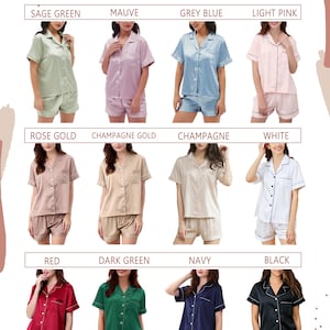 May include: Twelve different color variations of a short-sleeved pajama set with matching shorts. The pajamas are made of satin and have a button-up front. The colors include sage green, mauve, grey blue, light pink, rose gold, champagne gold, champagne, white, red, dark green, navy, and black.