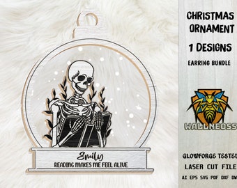 May include: A black and white digital design of a skeleton reading a book inside a snow globe ornament. The ornament has a wooden base with the text "Emily Reading Makes Me Feel Alive".