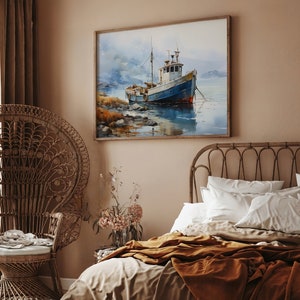 May include: A watercolour painting of a blue and white fishing boat in a calm body of water. The boat is anchored in the water with mountains in the background. The painting is framed in a light wood frame and hangs on a light brown wall.