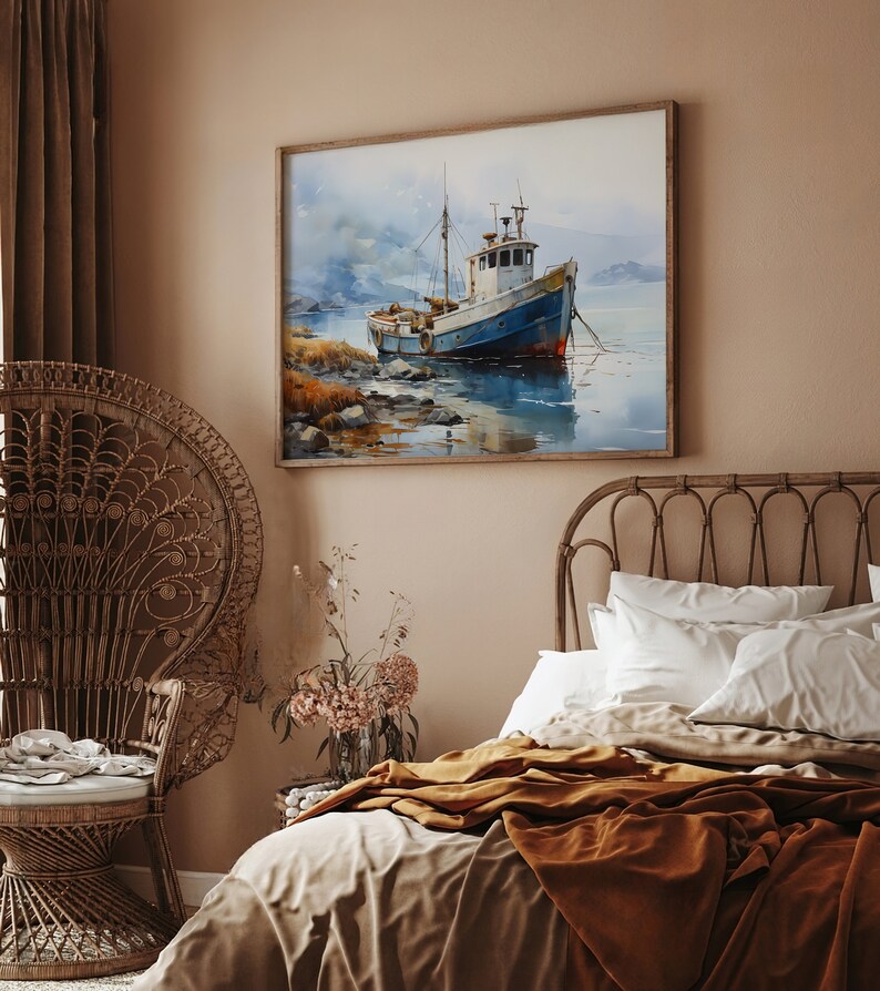 May include: A watercolour painting of a blue and white fishing boat in a calm body of water. The boat is anchored in the water with mountains in the background. The painting is framed in a light wood frame and hangs on a light brown wall.