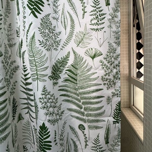 May include: White shower curtain with a green fern pattern. The ferns are in various sizes and shapes, creating a botanical design.