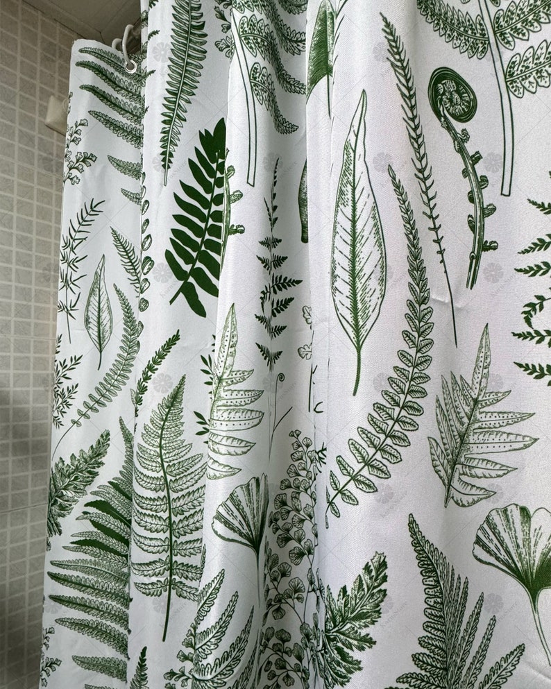May include: White shower curtain with a green fern pattern. The ferns are printed in a botanical style.