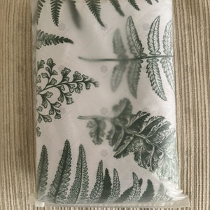 May include: A white pillowcase with a green fern pattern. The pillowcase is packaged in a clear plastic bag.