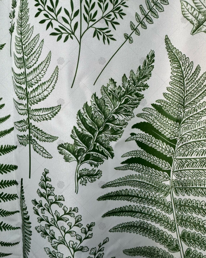 May include: White fabric with a green fern pattern. The ferns are printed in a dark green color and are arranged in a random pattern.