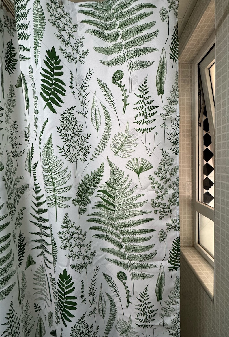 May include: White shower curtain with a green fern pattern. The ferns are in various sizes and shapes, creating a botanical design.