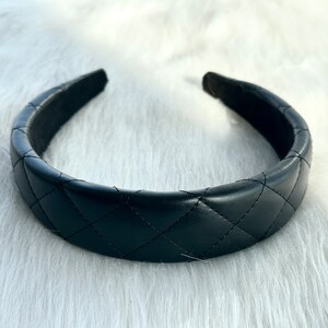 May include: A black quilted headband with a smooth, padded interior.