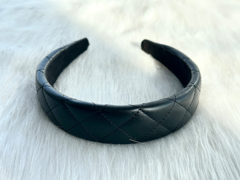 May include: A black quilted headband with a smooth, padded interior.
