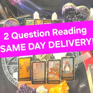 May include: A pink and white graphic with the text "2 Question Reading SAME DAY DELIVERY!"  The graphic is over a table with tarot cards, crystals, and a black and white circular pattern.