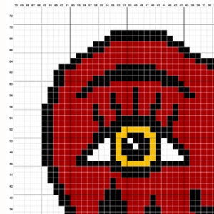 May include: Red and black pixel art design of a single eye with a gold ring around the iris. The eye is surrounded by a red circle.
