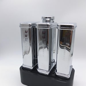 May include: Three silver Kenwood pasta makers with a black base. The pasta makers have a silver finish and a black knob on the top.