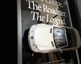 May include: A silver Mercedes-Benz SL500 convertible with the text "The Coupe. The Roadster. The Legend."  The 5th Generation SL is a dream car come true. A coupe that becomes a roadster in only 16 seconds. Technology that virtually thinks with the driver. Bloodlines racing back to the legendary 300 SL "gullwing" coupe. All of which path for future cars to follow. The new SL.