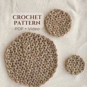 May include: Three circular crochet pieces in a light brown, natural fiber yarn, featuring a repeating star-like stitch pattern. The text CROCHET PATTERN PDF + Video is displayed in dark brown lettering on a light rectangular background.