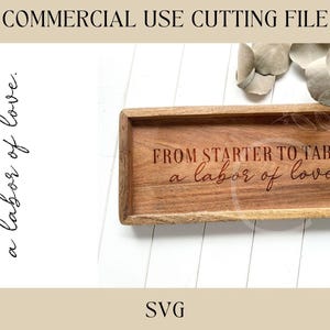 May include: A rectangular wooden tray with the engraved text "FROM STARTER TO TABLE, a labor of love." The tray is light brown and sits on a white surface. The words "COMMERCIAL USE CUTTING FILE" and "SVG" are also visible.