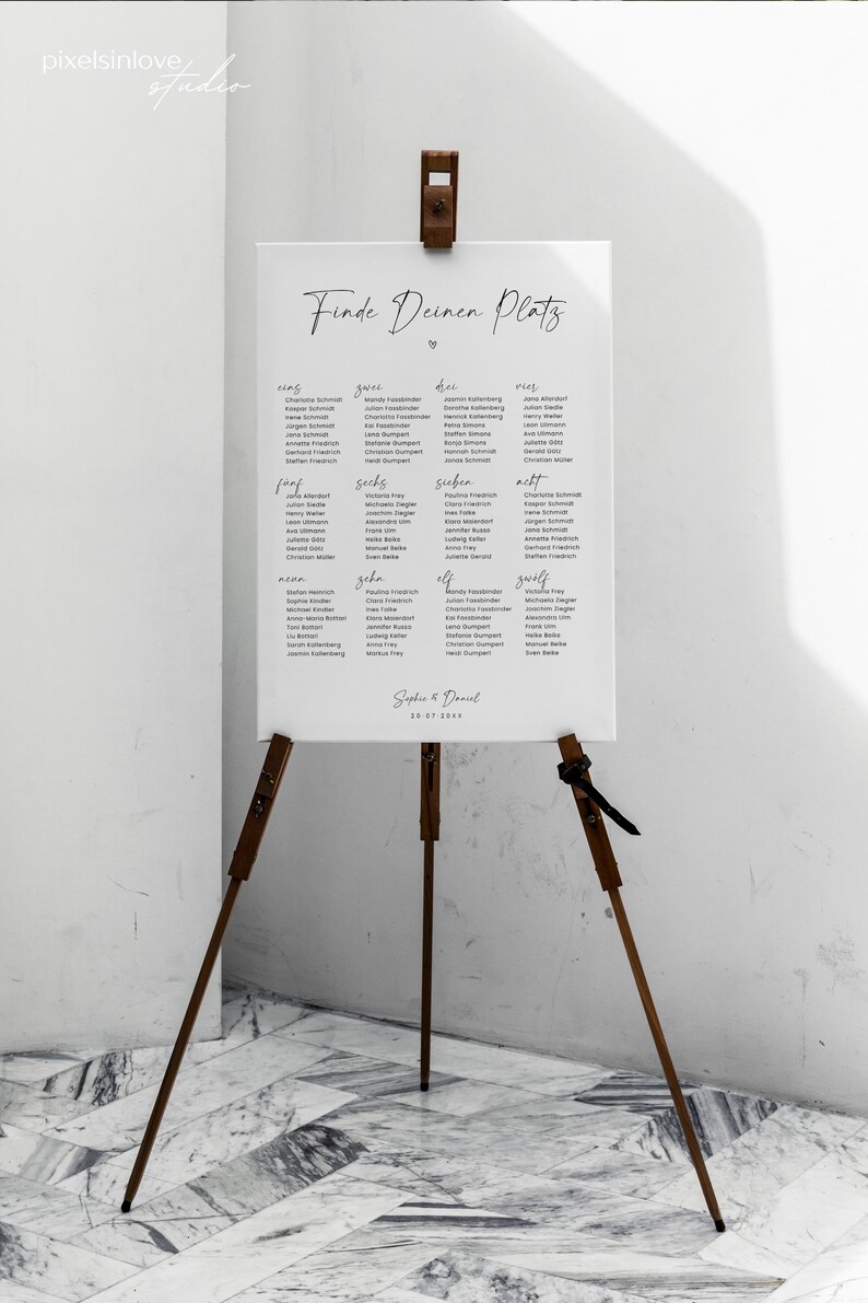 May include: A white seating chart with the title "Finde Deinen Platz" and a heart symbol. The chart lists names in German under the numbers one through eleven.