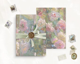 May include: A rectangular stationery set featuring an impressionistic oil painting of pink roses on a green background. The folded card is tied with a pale green ribbon and a gold wax seal. Several small postage stamps are scattered around the items.