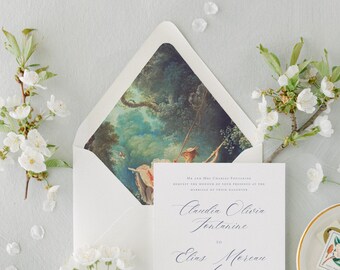 May include: A white wedding invitation card with black script text reading Claudia Olivia Fontanine to Elias Moreau, placed inside an envelope with a printed interior featuring a classical painting of a person on a swing in a lush green forest.