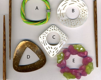 May include: Five different hair clips, each with a unique design. The clips are made of different materials, including wood, plastic, and metal. The clips are all in different colors, including green, white, brown, pink, and yellow.