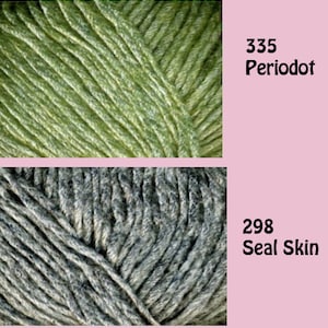 May include: Four skeins of yarn in different colors: a dark gray with silver flecks, a green, a light gray with silver flecks, and a dark blue. The yarn skeins are labeled with numbers and names: 295 Flinty, 335 Peridot, 298 Seal Skin, and 332 Laurel.