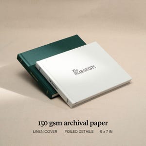 May include: Two guest books, one green and one white, are displayed. The white book, with the text "Our Dear Guests," is on top. The books are 9 x 7 inches and have linen covers and foiled details. The paper is 150 gsm archival.