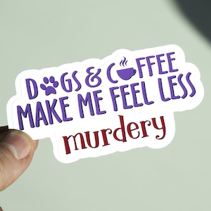 May include: Purple and white sticker with the text "Dogs & Coffee Make Me Feel Less Murdery". The sticker features a paw print and a coffee cup icon.