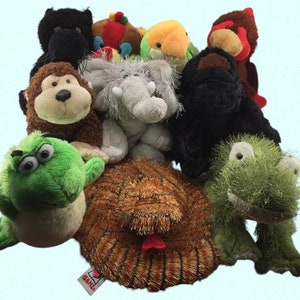 May include: A collection of plush toys, including a green frog, a brown turtle, a grey elephant, a black monkey, a black cat, a red bird, a green and yellow bird, and a black gorilla. The toys are all sitting on a white background.