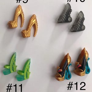 May include: Four pairs of miniature doll shoes labeled #9 through #12. Pair #9 are gold platform heels with textured details. Pair #10 are translucent grey cutout heels. Pair #11 are green leaf-themed platform sandals. Pair #12 are gold and black heels with blue snake-shaped heels.