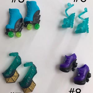 May include: Four pairs of doll shoes labeled #5 through #8. Pair #5 are blue roller skates with black accents and green wheels. Pair #6 are translucent teal strappy heels. Pair #7 are dark green heels with gold geometric bases. Pair #8 are purple boots.