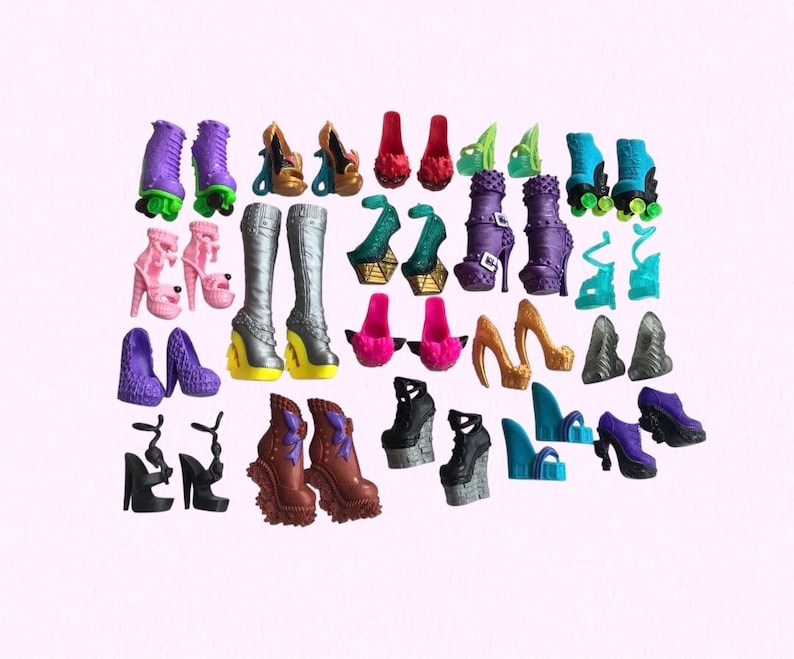 May include: A collection of miniature doll shoes in various styles and colors, including purple roller skates, silver knee-high boots, black platform heels, teal wedges, pink pumps, gold stilettos, and brown textured boots arranged on a plain background.