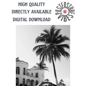 May include: Black and white photo of a classic car parked in front of a white house with palm trees. The car is a Porsche 911.