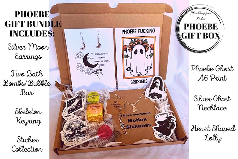 May include: A brown cardboard box filled with a variety of gifts, including a silver moon earring set, two bath bombs, a skeleton keyring, a sticker collection, a silver ghost necklace, a heart-shaped lollipop, and a print of a ghost with the text "Phoebe Fucking Bridgers".