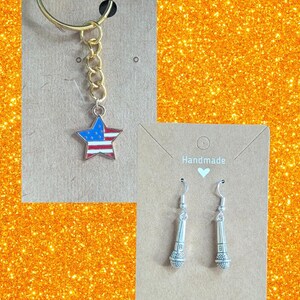 May include: A gold keychain with a star pendant featuring the American flag design. Also, a pair of silver microphone earrings are displayed on a brown card. The word "Handmade" is printed on the card.