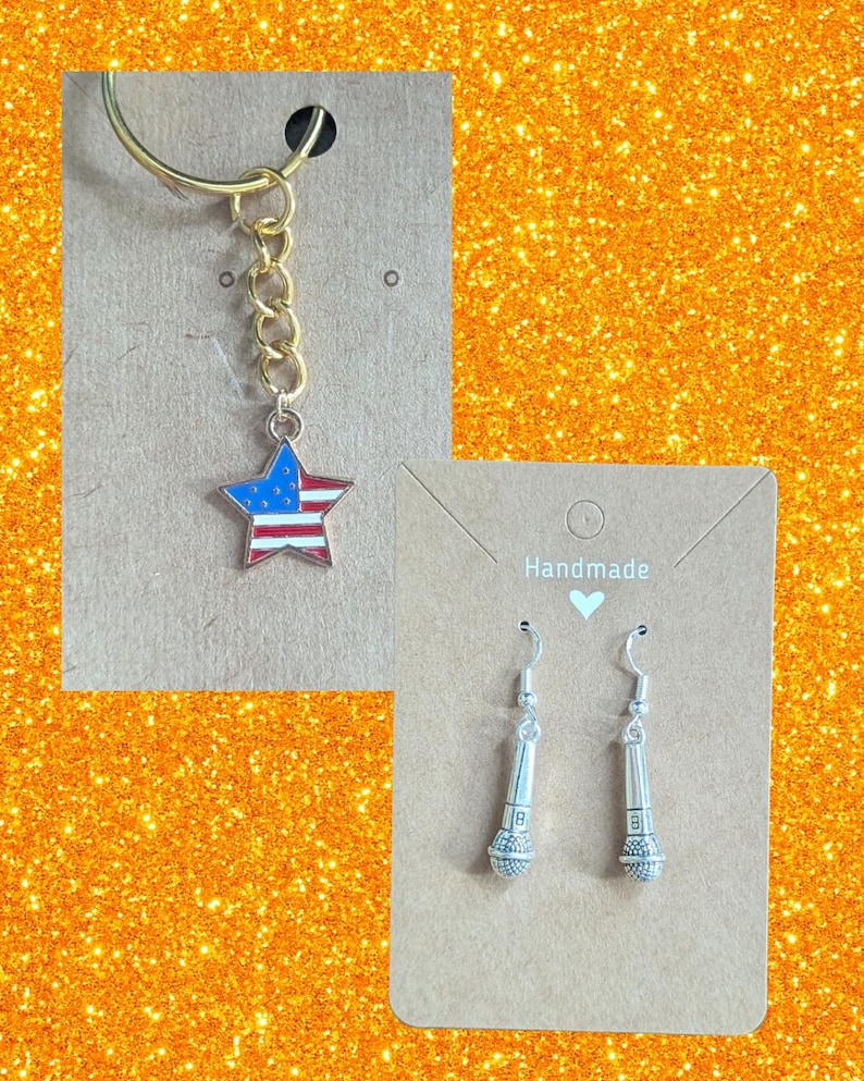 May include: A gold keychain with a star pendant featuring the American flag design. Also, a pair of silver microphone earrings are displayed on a brown card. The word "Handmade" is printed on the card.