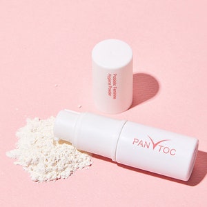 May include: A white tube of probiotic feminine hygiene powder with the text "Probiotic Feminine Hygiene Powder" on the side. The tube is open and the powder is spilling out. The tube is labeled "PANTOC" on the bottom.