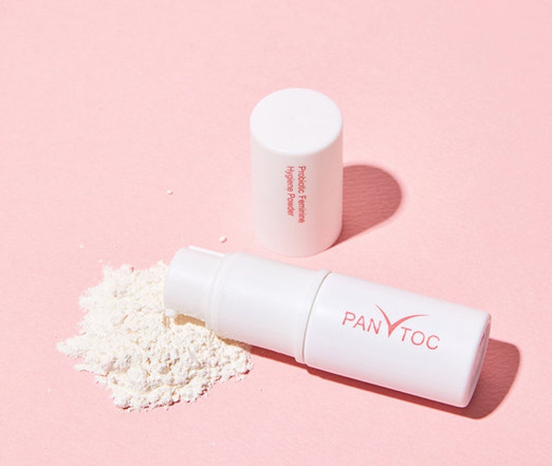 May include: A white tube of probiotic feminine hygiene powder with the text "Probiotic Feminine Hygiene Powder" on the side. The tube is open and the powder is spilling out. The tube is labeled "PANTOC" on the bottom.