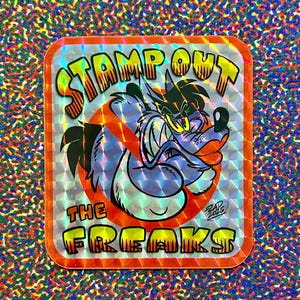 May include: Holographic sticker featuring a cartoon wolf illustration within a red circle with a red line through it. The text "STAMP OUT THE FREAKS" is in yellow and orange bubble letters. The sticker has an orange border.