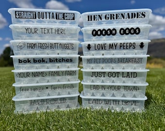 May include: Clear plastic egg cartons stacked on green grass, each labeled with black text. Phrases include "STRAIGHT OUTTA THE COOP", "HEN GRENADES", and "FRESH EGGS". Other labels include "FARM FRESH BUTT NUGGETS" and "LOVE MY PEEPS".