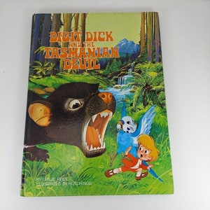 May include: A book cover with a colorful illustration of a Tasmanian devil, a blue bird, and a boy. The title of the book is "Digit Dick and the Tasmanian Devil" by Leslie Rees, illustrated by Hutchings.